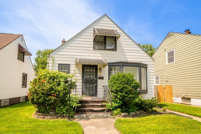 bungalow-style home with a front yard