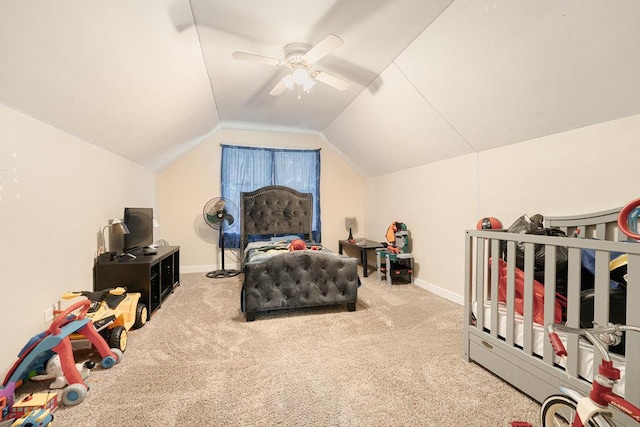 carpeted bedroom with lofted ceiling, baseboards, and a ceiling fan