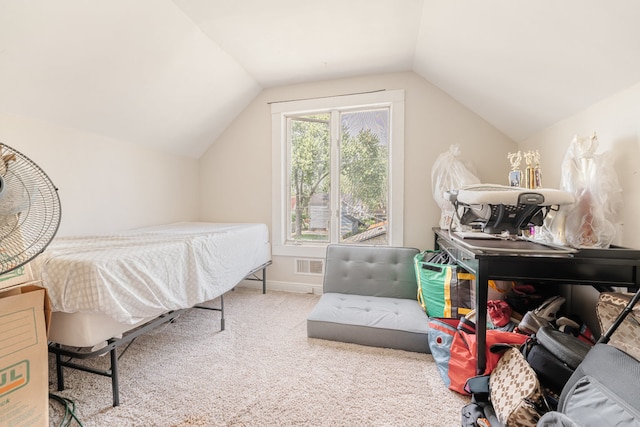 bedroom with lofted ceiling and carpet floors