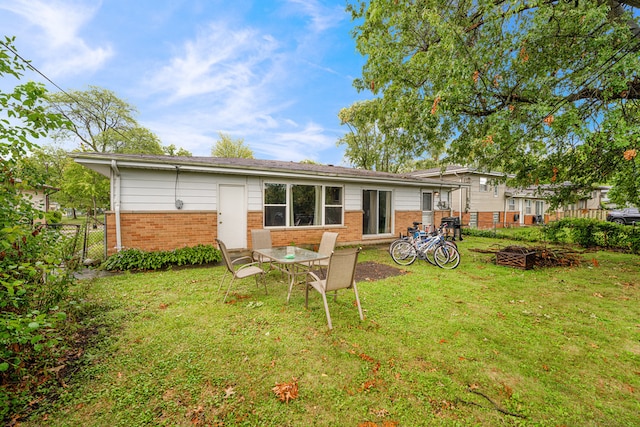 rear view of property featuring a lawn