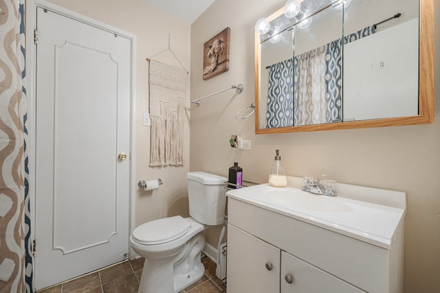 bathroom featuring tile patterned floors, vanity, and toilet