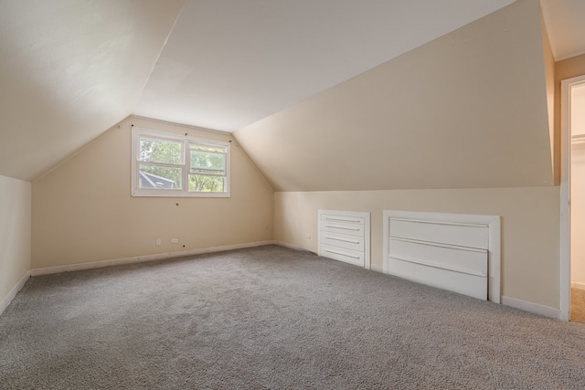 bonus room featuring lofted ceiling and carpet flooring