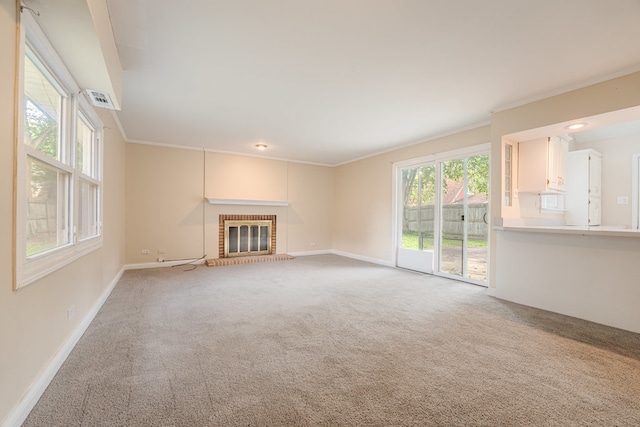 unfurnished living room with crown molding, light carpet, and a brick fireplace