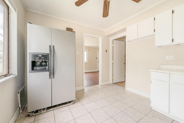 kitchen with crown molding, light countertops, fridge with ice dispenser, and a ceiling fan