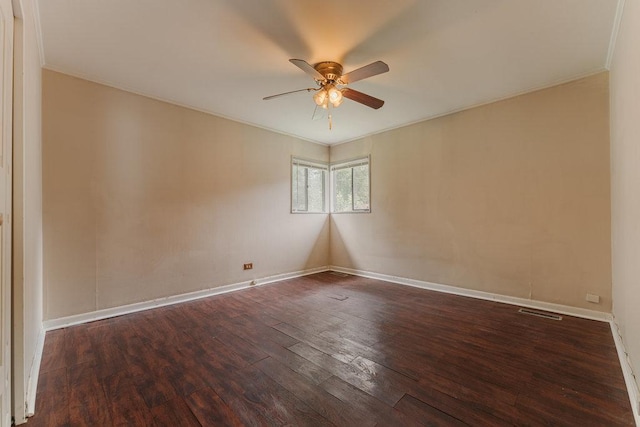 spare room featuring ceiling fan, crown molding, wood finished floors, and baseboards