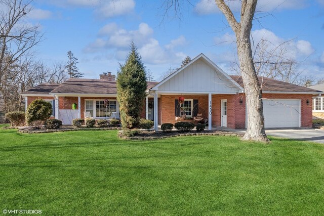 single story home featuring a garage, a front yard, and covered porch