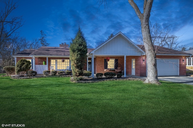 ranch-style home with a garage, a porch, and a lawn