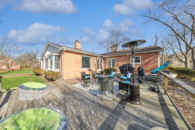 rear view of property featuring a deck and outdoor lounge area