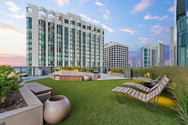 view of home's community featuring a city view and a lawn