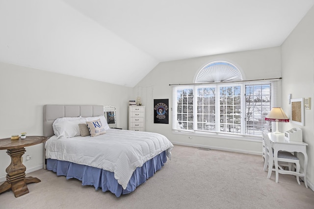 bedroom featuring light carpet and vaulted ceiling