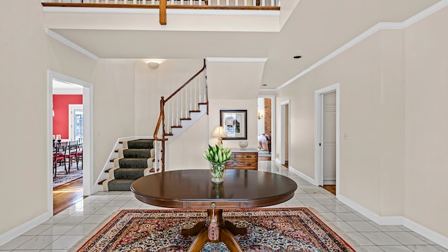 tiled foyer with ornamental molding