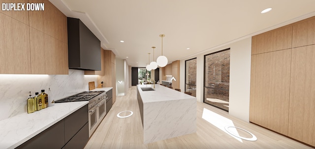 kitchen featuring range with two ovens, light hardwood / wood-style flooring, decorative light fixtures, a center island, and light brown cabinets