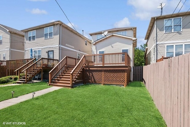 back of house with a deck and a lawn