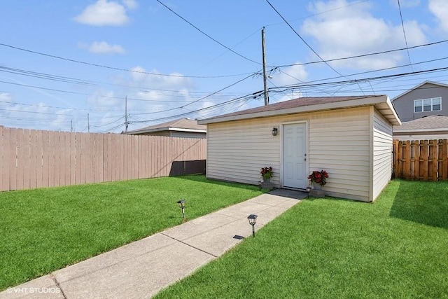 view of outdoor structure featuring a lawn