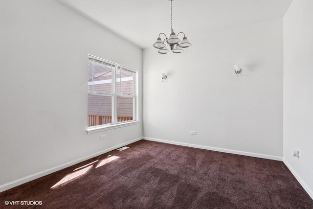 carpeted spare room with an inviting chandelier