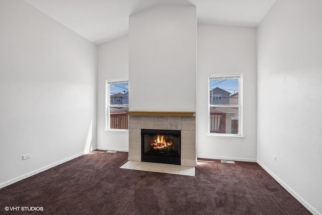 unfurnished living room with light carpet, a fireplace, and high vaulted ceiling