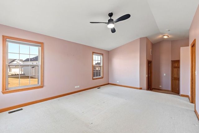 carpeted spare room with vaulted ceiling and ceiling fan