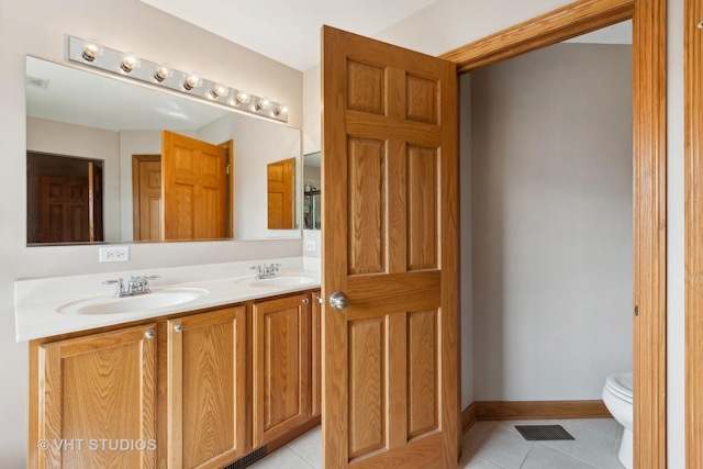 bathroom featuring tile patterned floors, toilet, and vanity