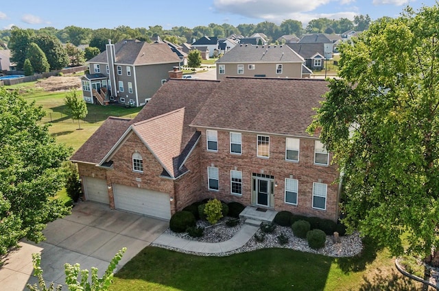 view of front of property featuring a garage and a front lawn