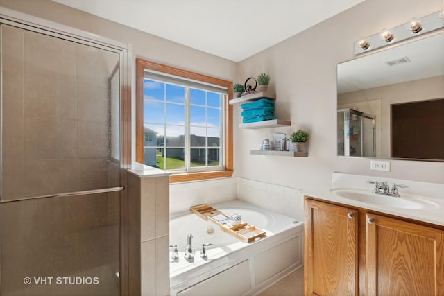 bathroom with vanity and independent shower and bath