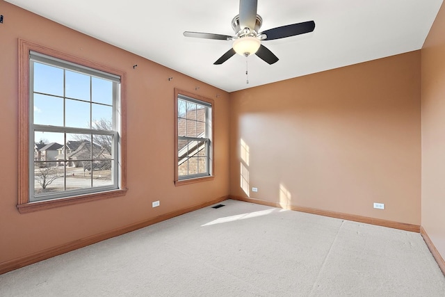 spare room featuring carpet floors and ceiling fan