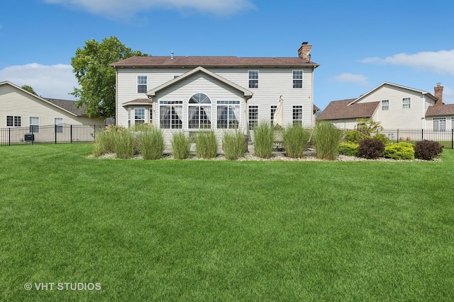 rear view of house with a lawn