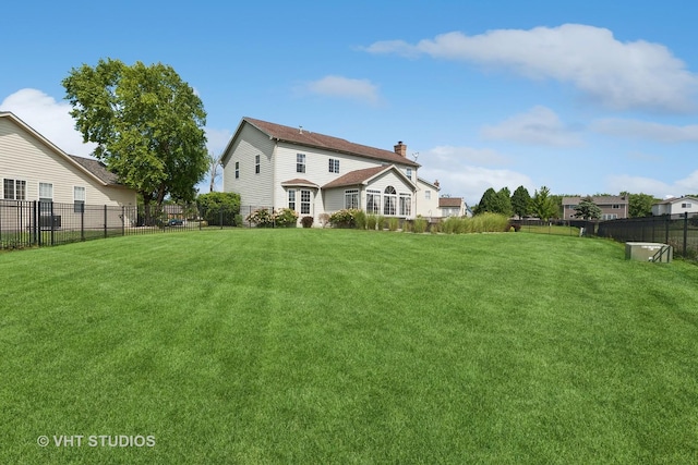 back of house with a yard