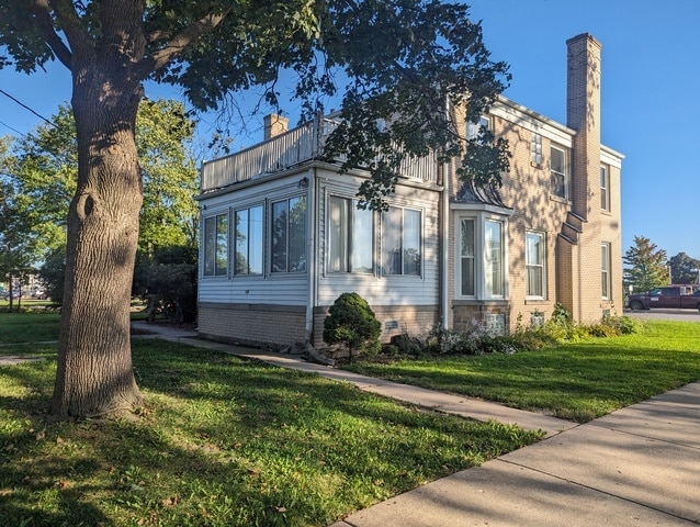 view of property exterior with a lawn