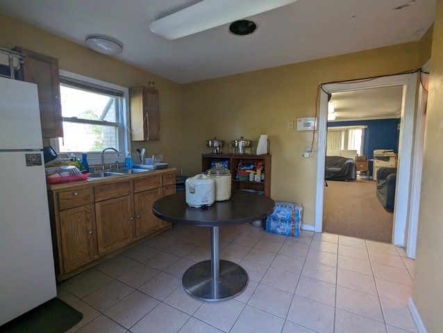 kitchen featuring sink, white fridge, and light tile patterned floors