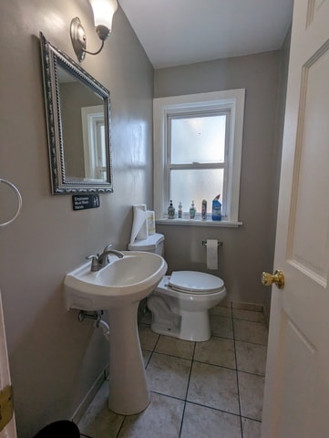 bathroom featuring tile patterned flooring and toilet