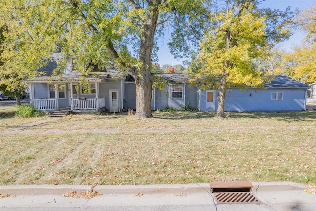 view of front of property with a front yard and a porch