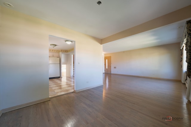 empty room with hardwood / wood-style floors