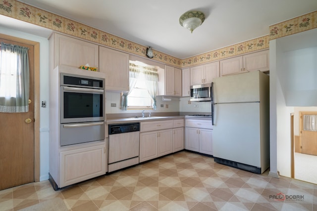 kitchen featuring appliances with stainless steel finishes, backsplash, and sink