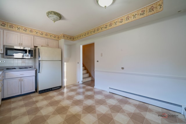 kitchen with decorative backsplash, white appliances, and a baseboard heating unit