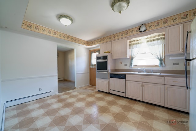 kitchen featuring sink, stainless steel appliances, and baseboard heating