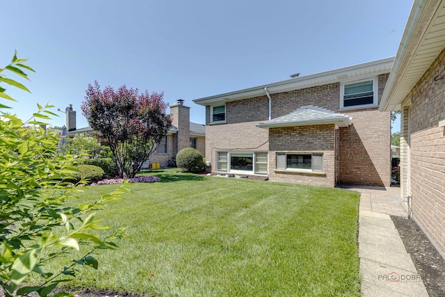 rear view of property with a yard