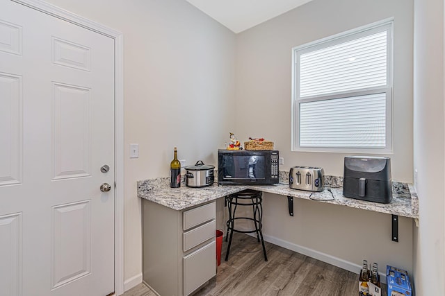 office area featuring light wood finished floors and baseboards