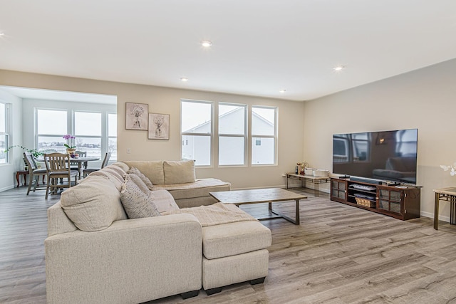 living room featuring recessed lighting, light wood-type flooring, and baseboards