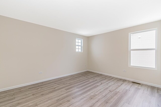 unfurnished room with light wood-type flooring