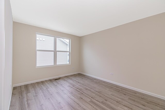 spare room with light wood-type flooring