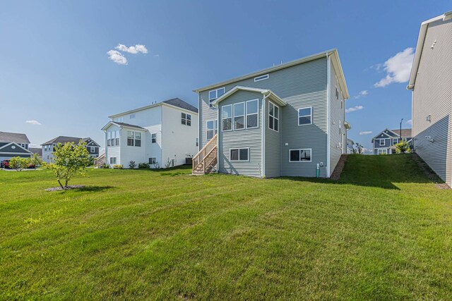 rear view of property with a yard