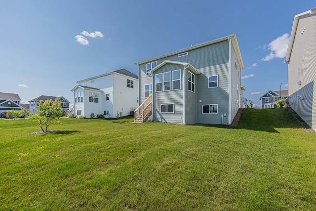 rear view of house with a residential view and a lawn