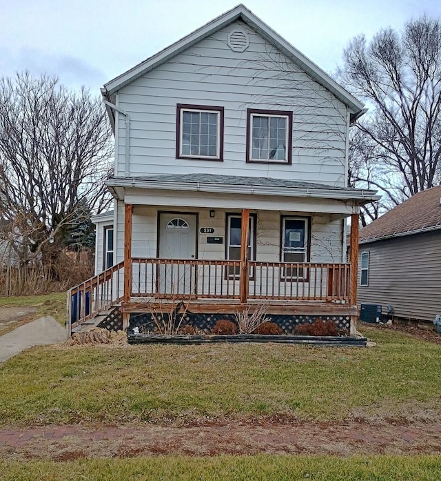 view of front of property with a porch, central AC, and a front lawn