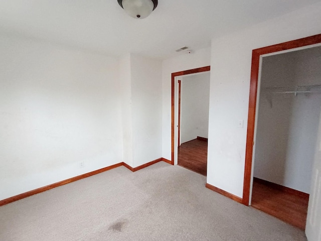 unfurnished bedroom featuring carpet floors and a closet