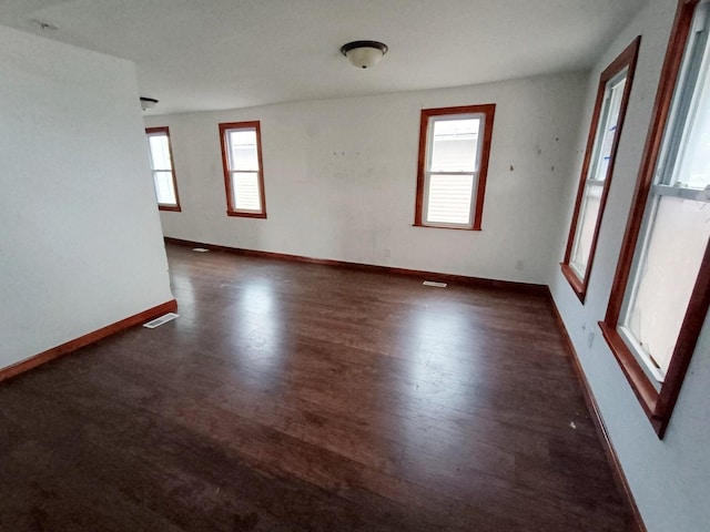 spare room with dark hardwood / wood-style flooring