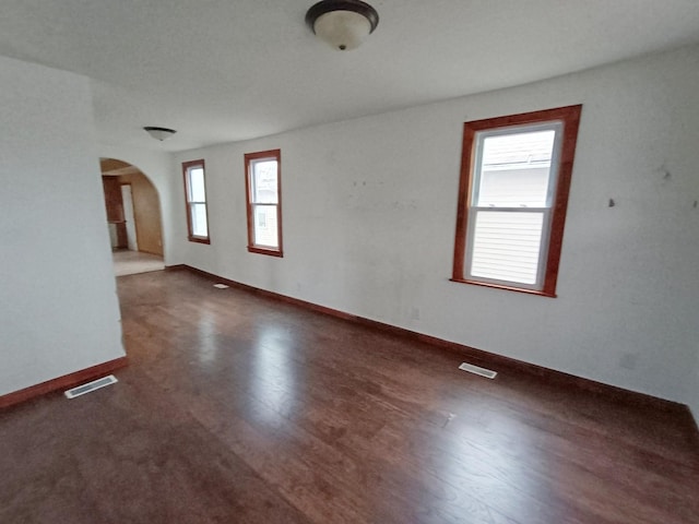 empty room with dark hardwood / wood-style floors