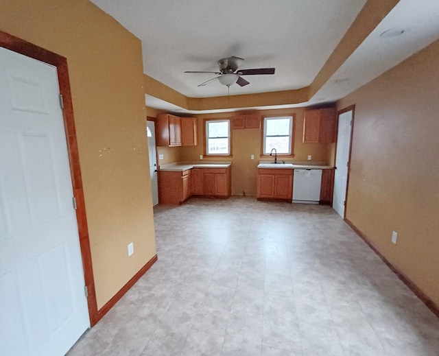 kitchen featuring ceiling fan, sink, and white dishwasher