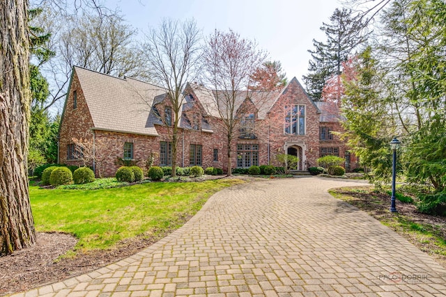 964 Lake Rd, Lake Forest, IL 60045 - english style home with curved driveway, a front lawn, and brick siding
