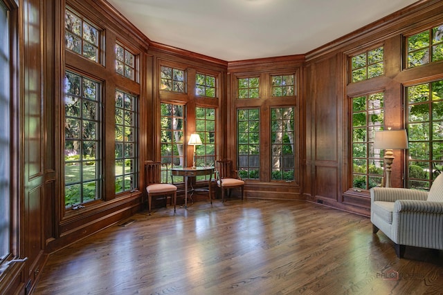 unfurnished room with dark wood-type flooring and wooden walls