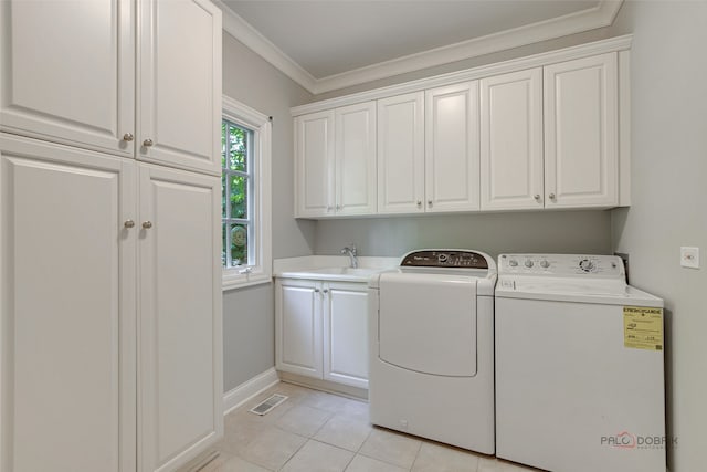 laundry room with washer and clothes dryer, sink, cabinets, light tile patterned floors, and crown molding